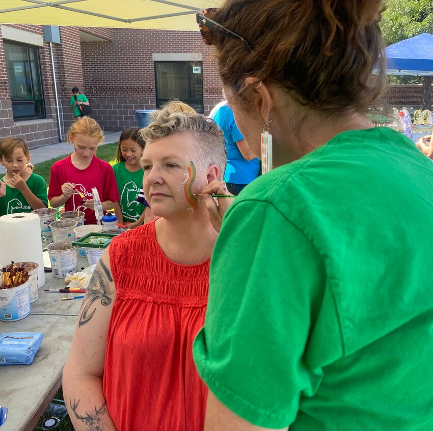 Betty Adams Elementary parent Vania Smith gets her face painted by the school's visual arts teacher Elizabeth Powis Fulks during the Sept. 9 park dedication.